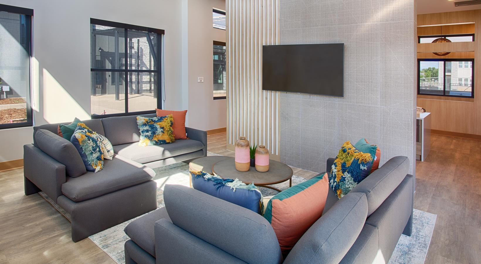 a spacious room with a sofa and tv