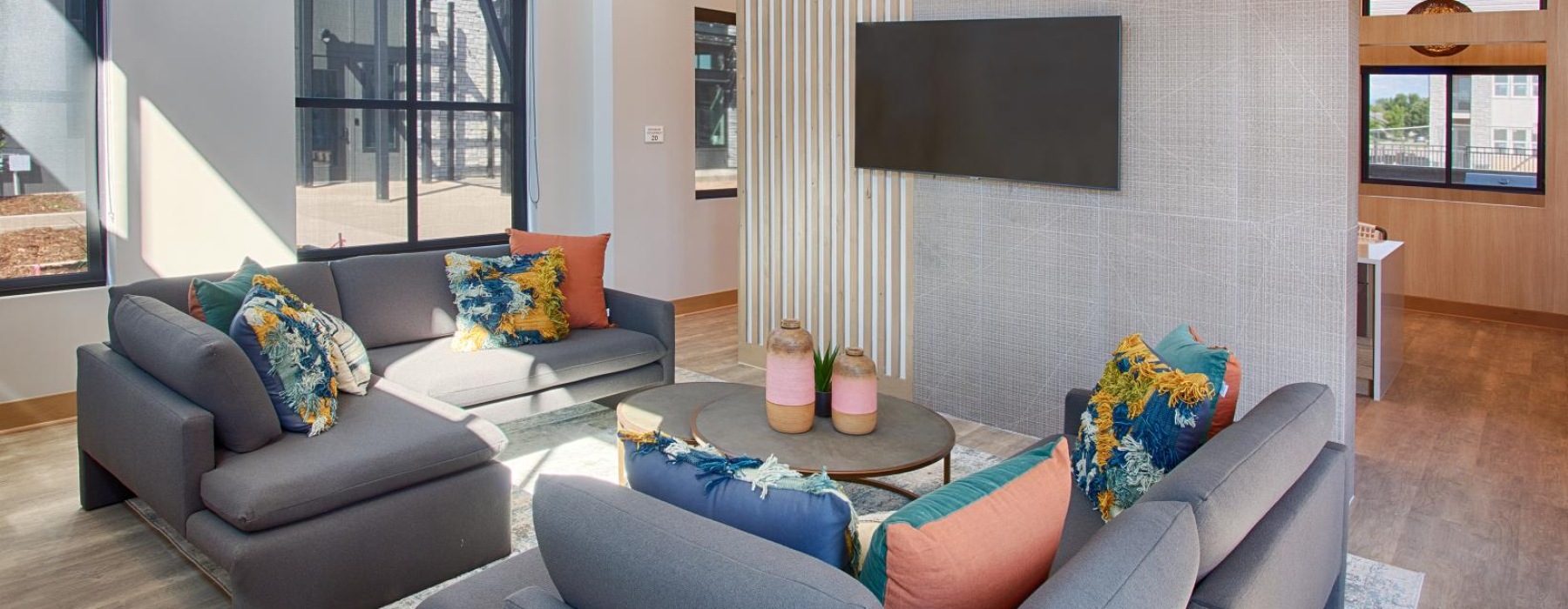 a spacious room with a sofa and tv