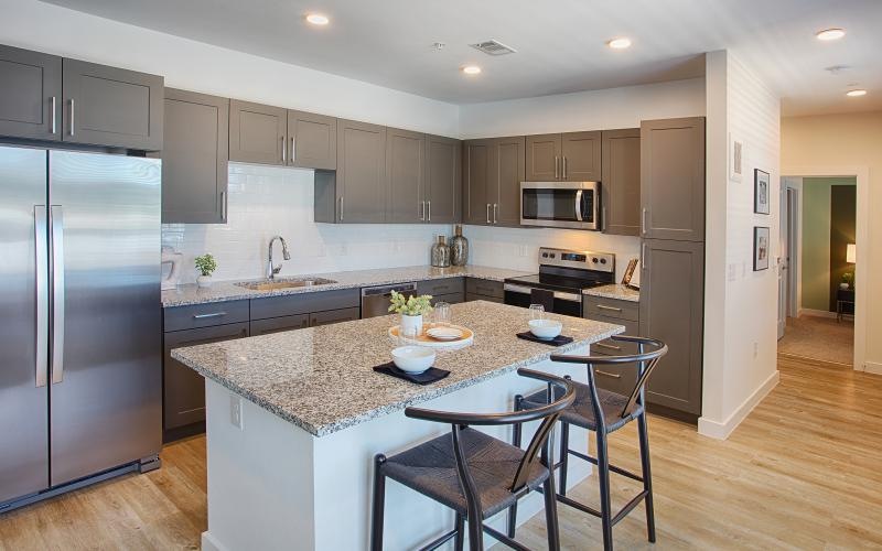 a kitchen with a marble island