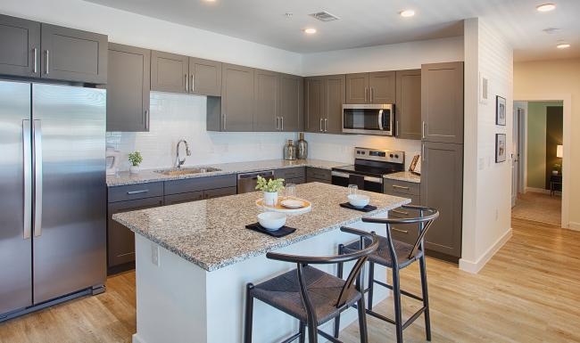 a kitchen with a marble island